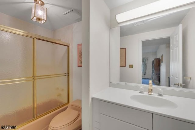 full bath featuring toilet, combined bath / shower with glass door, and vanity