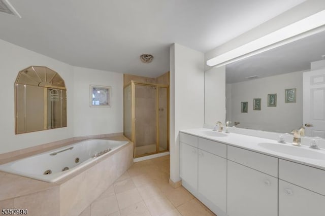 full bath featuring a shower stall, a jetted tub, double vanity, and tile patterned flooring