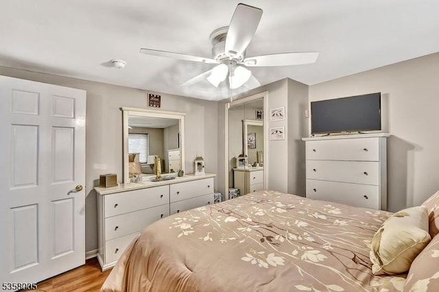 bedroom with light wood finished floors and ceiling fan