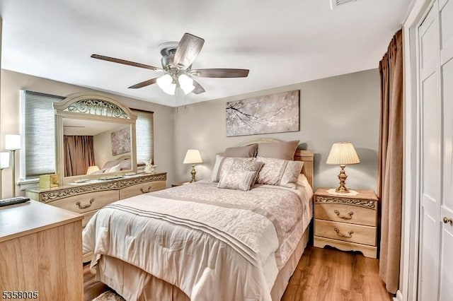 bedroom featuring light wood-type flooring and a ceiling fan