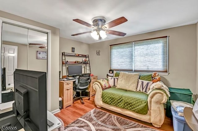 home office with ceiling fan and light wood-style flooring