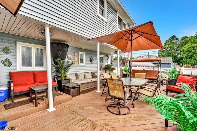 deck with outdoor lounge area and outdoor dining space
