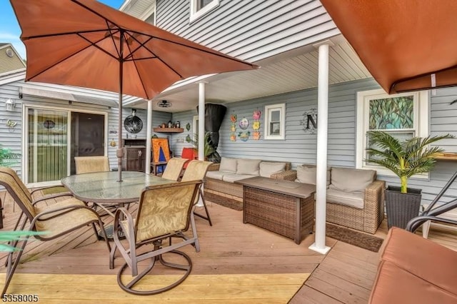 wooden terrace with outdoor dining area and an outdoor living space