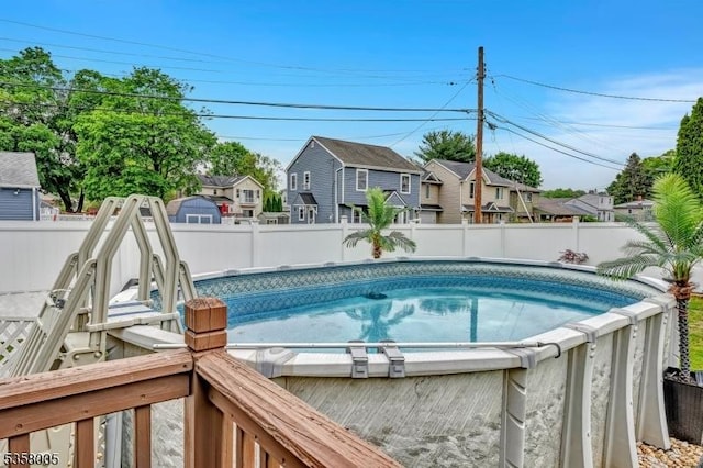 view of pool featuring a fenced backyard and a residential view