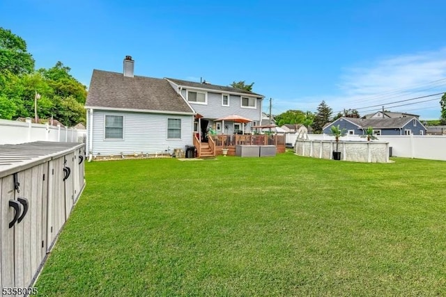 back of house with a pool, a chimney, and a deck