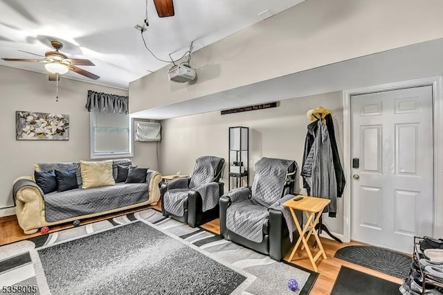 home theater featuring ceiling fan and light wood finished floors