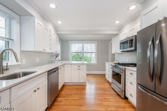 537 Summit Ave, Maplewood Twp, NJ 07040 - kitchen with stainless steel appliances, crown molding, a sink, white cabinets, and light countertops