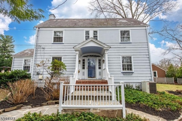 537 Summit Ave, Maplewood Twp, NJ 07040 - view of front of house with central AC, a chimney, and fence
