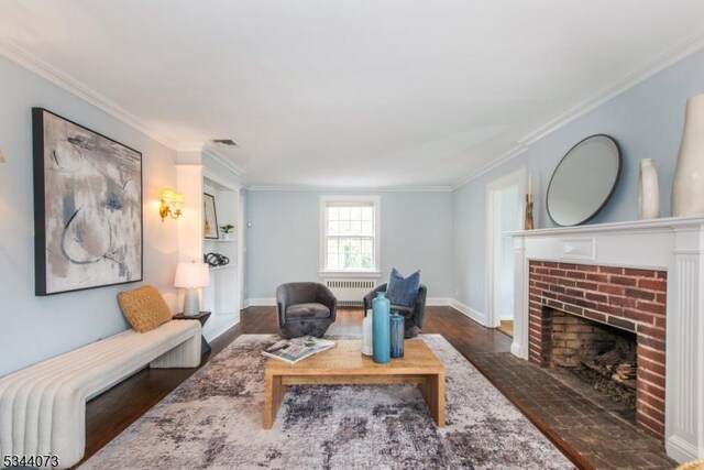537 Summit Ave, Maplewood Twp, NJ 07040 - living area featuring radiator heating unit, wood finished floors, a fireplace, crown molding, and baseboards