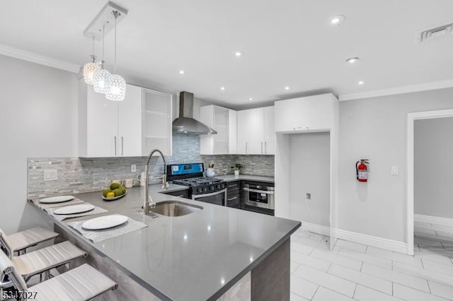 1218 Kline Pl, Rahway City, NJ 07065 - kitchen with wall chimney exhaust hood, appliances with stainless steel finishes, a sink, a peninsula, and decorative backsplash