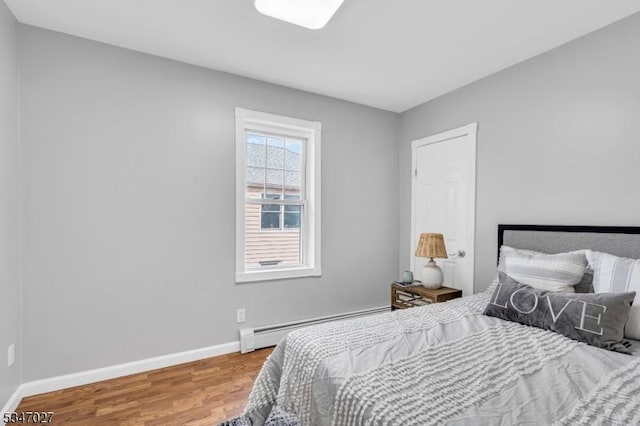 1218 Kline Pl, Rahway City, NJ 07065 - bedroom featuring baseboard heating, wood finished floors, and baseboards
