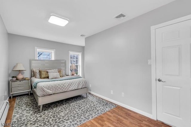 1218 Kline Pl, Rahway City, NJ 07065 - bedroom featuring baseboard heating, wood finished floors, and baseboards