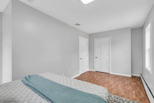 1218 Kline Pl, Rahway City, NJ 07065 - bedroom with a baseboard radiator, wood finished floors, and baseboards