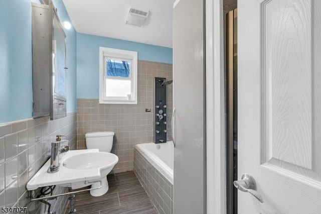 1218 Kline Pl, Rahway City, NJ 07065 - full bath with tile walls, toilet, a sink, tiled shower / bath, and wood finished floors