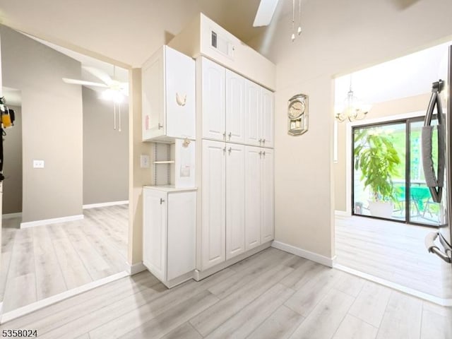 kitchen with a ceiling fan, light wood-type flooring, and white cabinets