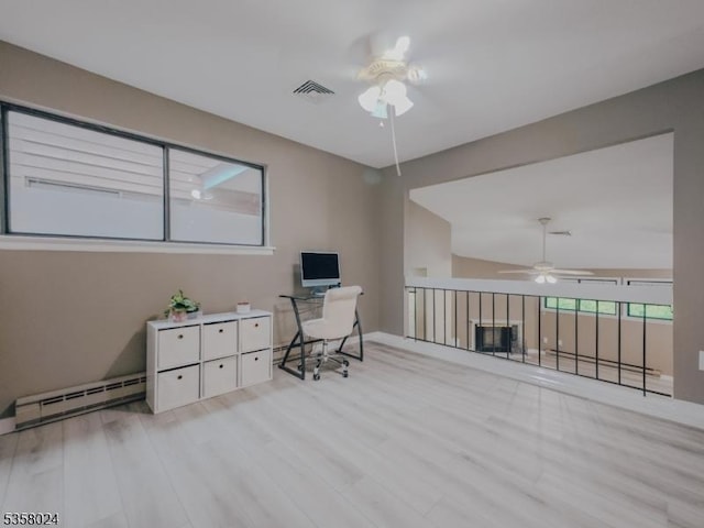 office space with a ceiling fan, baseboard heating, wood finished floors, and baseboards