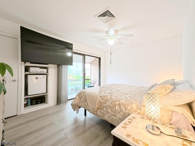 bedroom featuring access to exterior, light wood finished floors, and ceiling fan