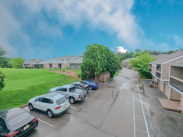 uncovered parking lot with a residential view