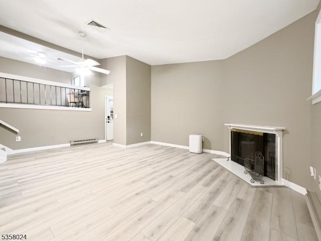 unfurnished living room with a glass covered fireplace, wood finished floors, baseboards, a ceiling fan, and a baseboard radiator