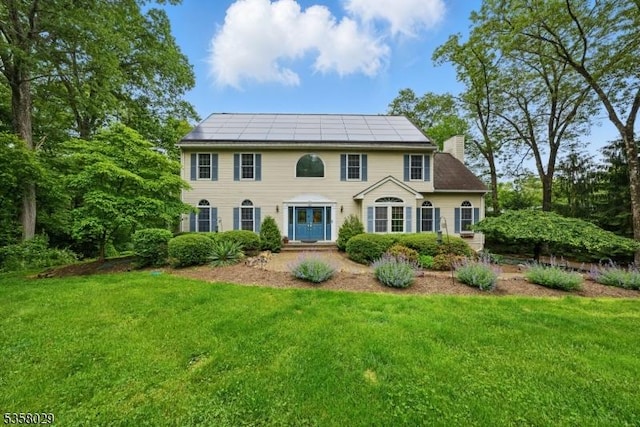 21 Sheep Hill Rd, Boonton Twp, NJ 07005 - colonial-style house with a chimney, a front yard, and solar panels