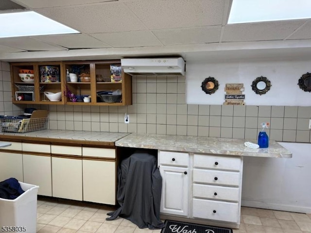 64 Dater St, North Haledon Boro, NJ 07508 - kitchen with under cabinet range hood, decorative backsplash, white cabinetry, a drop ceiling, and open shelves