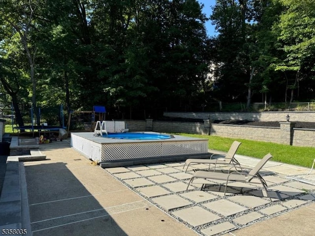 64 Dater St, North Haledon Boro, NJ 07508 - swimming pool with a patio area and view of scattered trees