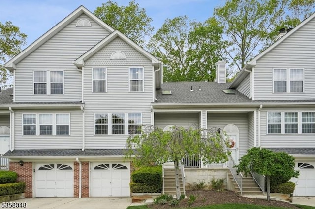 121 Wingate Dr, Independence Twp, NJ 07840 - view of front facade with an attached garage, concrete driveway, a chimney, roof with shingles, and brick siding