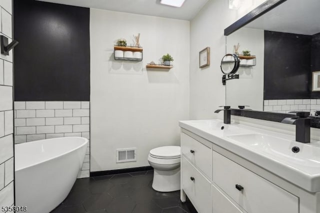 121 Wingate Dr, Independence Twp, NJ 07840 - bathroom featuring double vanity, a freestanding bath, toilet, tile patterned floors, and tile walls