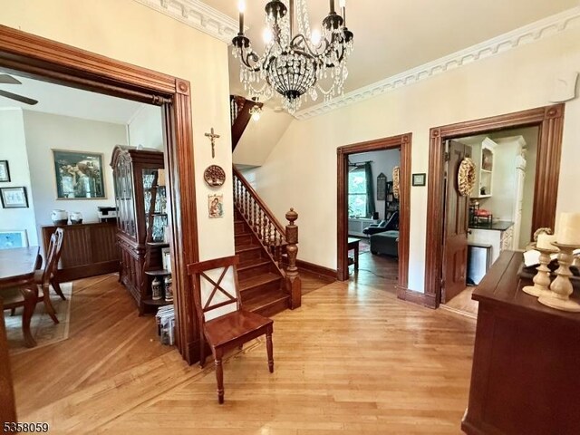 208 Rockaway St, Boonton Town, NJ 07005 - foyer with light wood-style flooring, stairway, a chandelier, baseboards, and ornamental molding