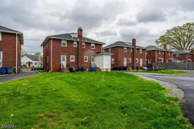 2516-2518 Allen Ave, Union Twp, NJ 07083 - back of property featuring entry steps, brick siding, a chimney, cooling unit, and a residential view