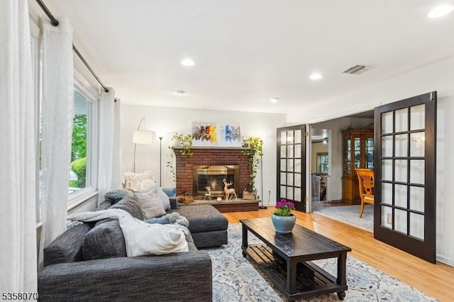 95 Union Ave, Edison Twp, NJ 08820 - living area with wood finished floors, recessed lighting, a brick fireplace, and french doors