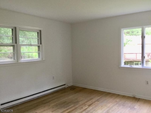 78 Hillside Ter, Green Twp, NJ 07821 - spare room featuring a baseboard heating unit, light wood-type flooring, and baseboards