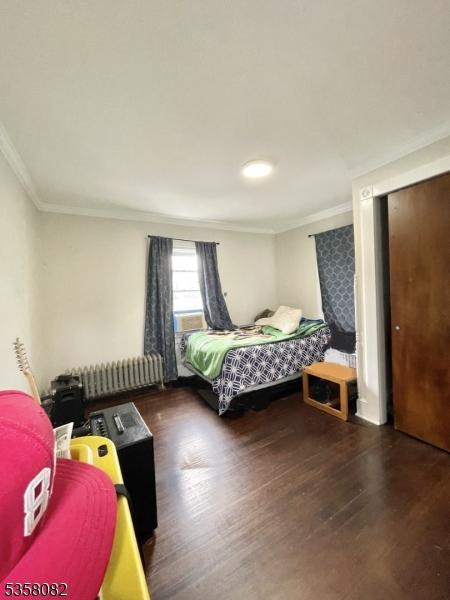 277 Watchung Ave, North Plainfield Boro, NJ 07060 - bedroom featuring radiator heating unit, ornamental molding, and wood finished floors