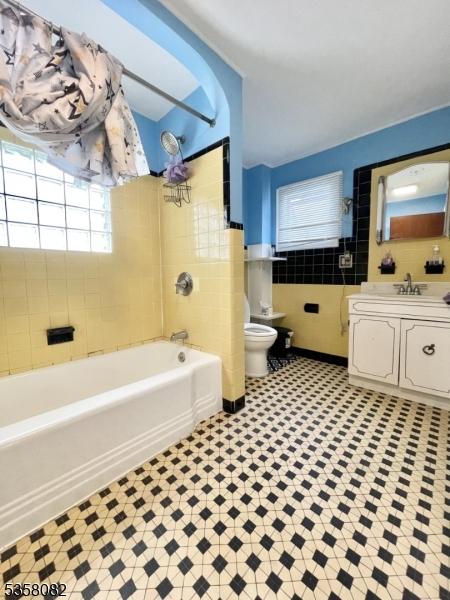 277 Watchung Ave, North Plainfield Boro, NJ 07060 - bathroom featuring toilet, vanity, tile patterned floors, and  shower combination