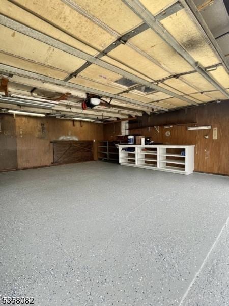 277 Watchung Ave, North Plainfield Boro, NJ 07060 - garage with wood walls and a garage door opener