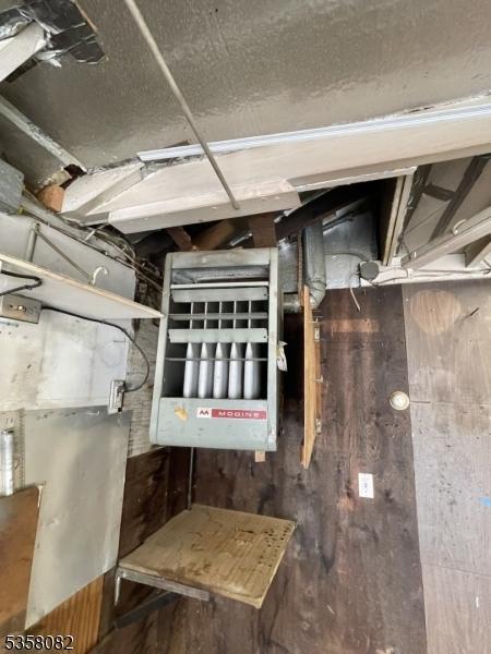 277 Watchung Ave, North Plainfield Boro, NJ 07060 - unfinished basement featuring wooden walls and a heating unit