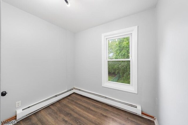1353 W 3rd St, Plainfield City, NJ 07063 - unfurnished room featuring a baseboard heating unit, dark wood finished floors, and a baseboard radiator