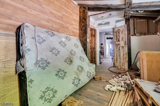 miscellaneous room with wooden walls and wood finished floors
