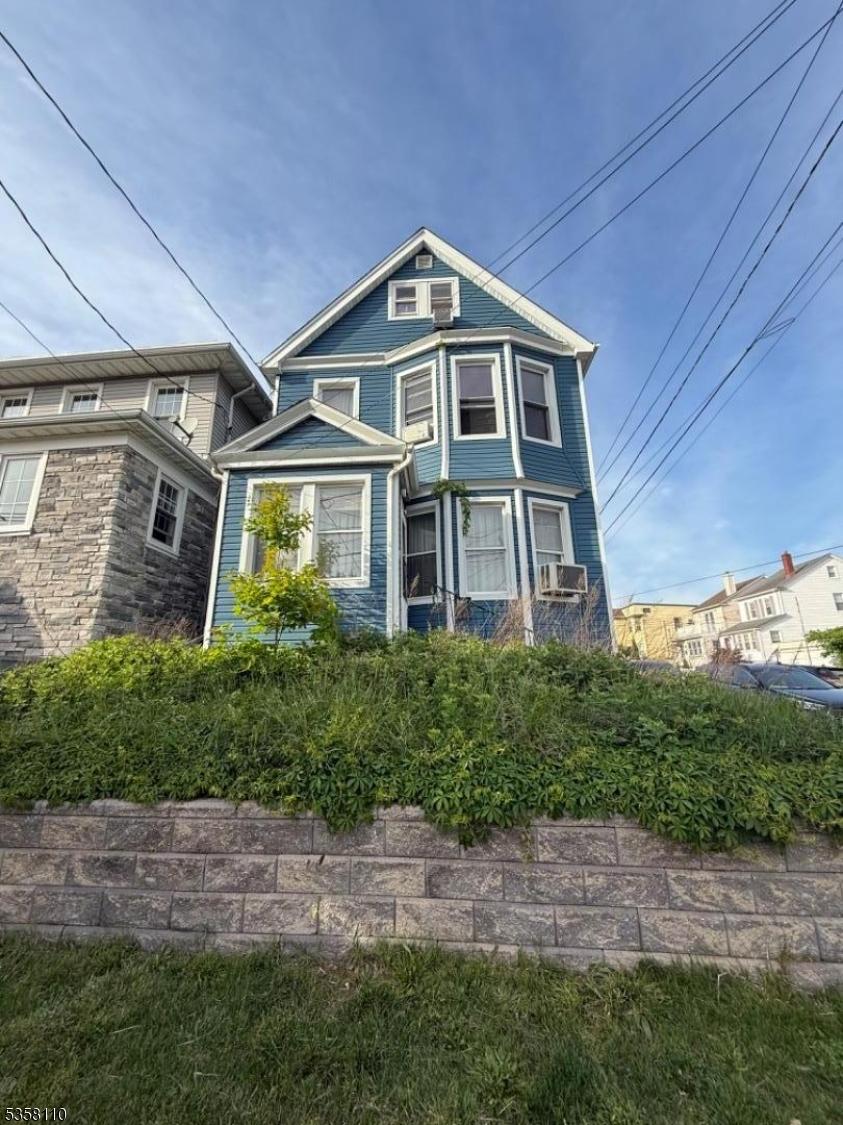 19 Wilson Ave, Kearny Town, NJ 07032 - victorian house with stone siding and cooling unit