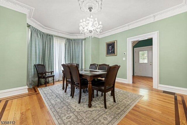 208 W Milton Ave, Rahway City, NJ 07065 - dining area featuring crown molding, a chandelier, baseboards, and light wood-style floors