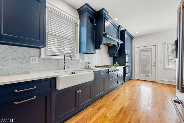 208 W Milton Ave, Rahway City, NJ 07065 - kitchen with a sink, blue cabinetry, stainless steel appliances, and tasteful backsplash
