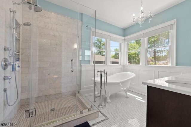 208 W Milton Ave, Rahway City, NJ 07065 - full bath with a stall shower, a freestanding tub, a chandelier, vanity, and tile patterned flooring