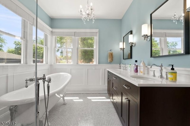 208 W Milton Ave, Rahway City, NJ 07065 - full bathroom with a chandelier, plenty of natural light, a freestanding tub, a decorative wall, and wainscoting