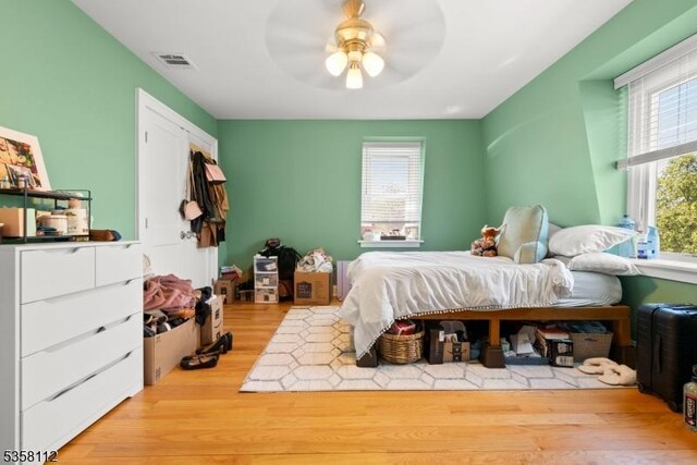 208 W Milton Ave, Rahway City, NJ 07065 - bedroom with multiple windows, wood finished floors, and a ceiling fan