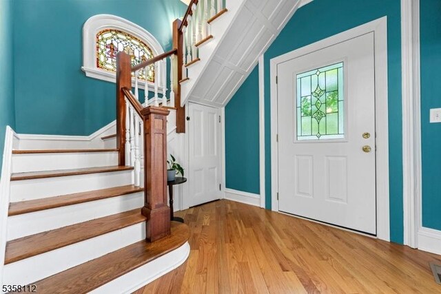 208 W Milton Ave, Rahway City, NJ 07065 - foyer with vaulted ceiling, wood finished floors, and stairway
