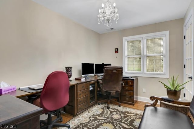 office with a chandelier, wood finished floors, and baseboards