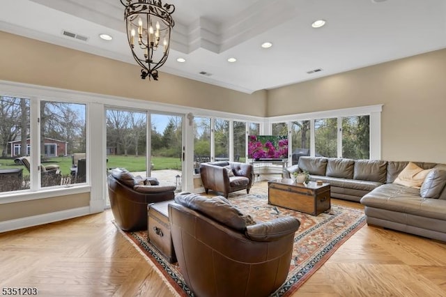living room featuring recessed lighting, a chandelier, baseboards, and a high ceiling