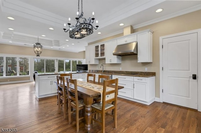 dining area with a chandelier, crown molding, dark wood-style floors, and recessed lighting
