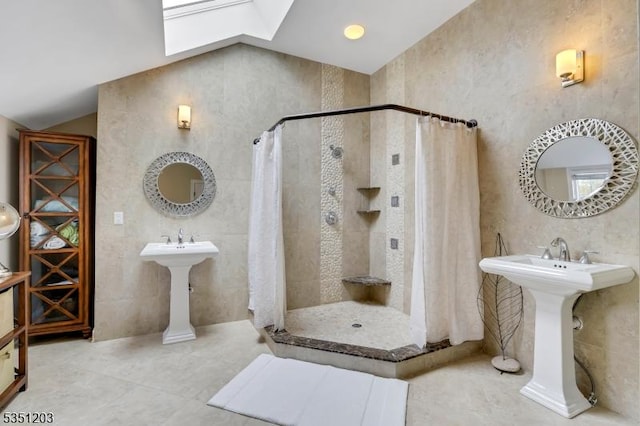full bathroom featuring a tile shower, tile walls, a skylight, and tile patterned flooring