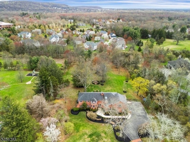 view of subject property featuring a heavily wooded area